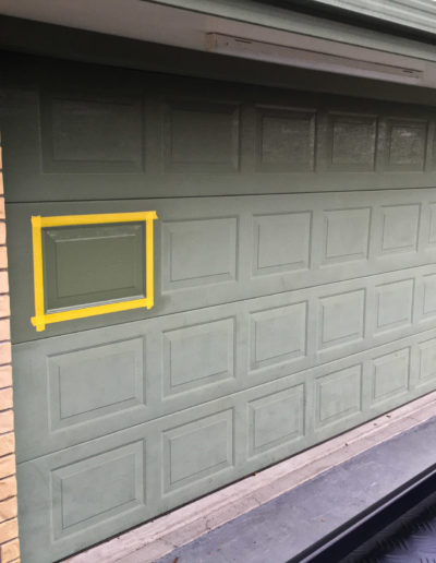 Wider view of garage door section after coating applied