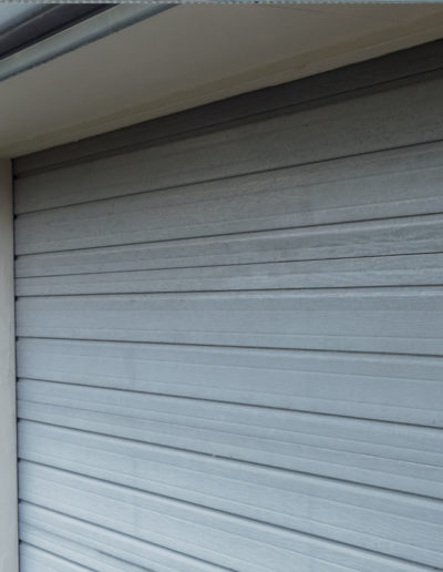 Side view of garage door before cleaning for restoration coating