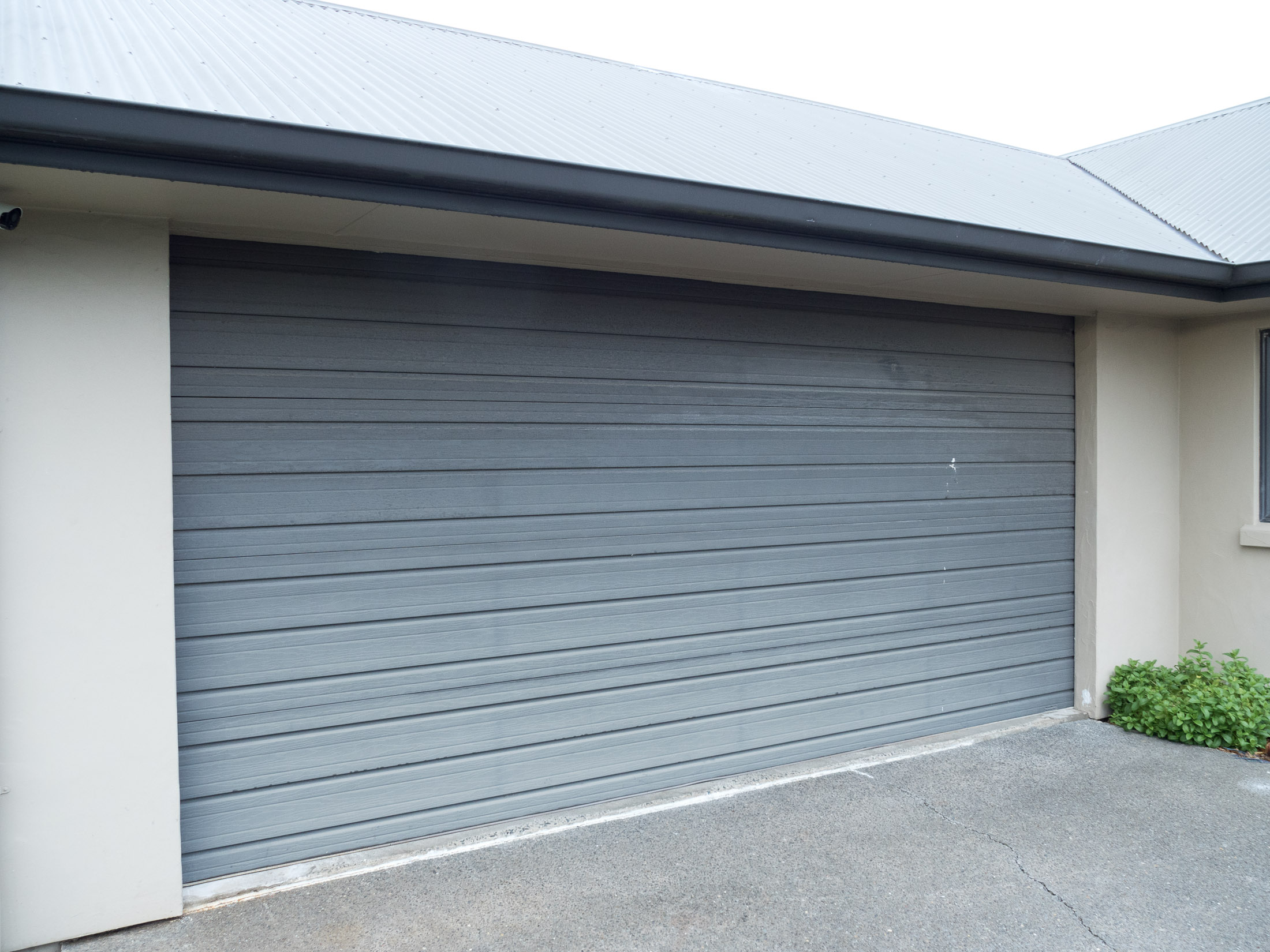 Restoring and Protecting UV Damaged Dark Brown Garage Door