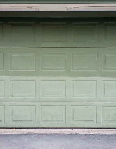 Top section of garage door cleaned ready for coating with test area